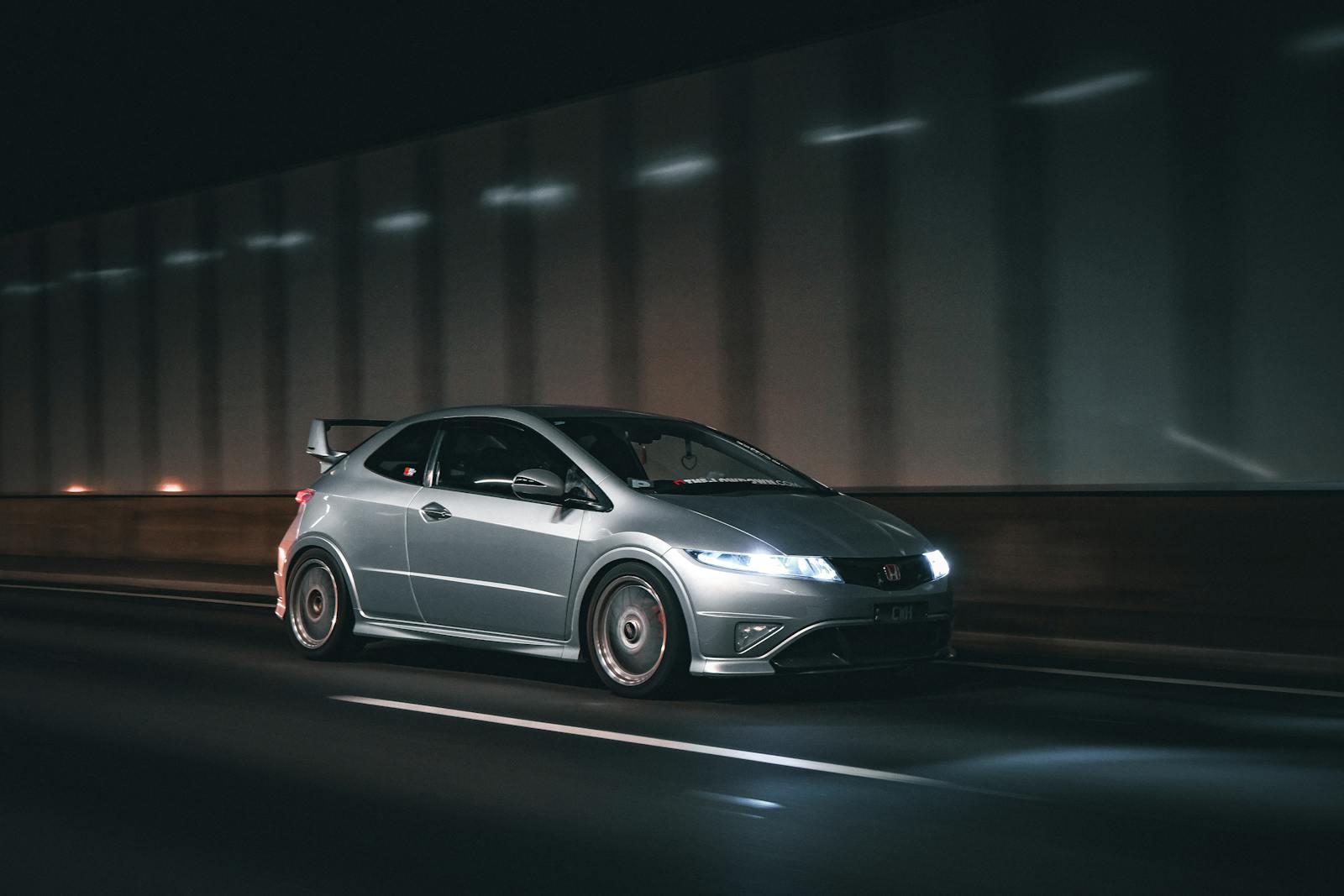 A car driving on the road at night