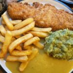 Savoring the Classic: A Dive into Fish ‘N’ Chips with a Twist of Curry and Peas