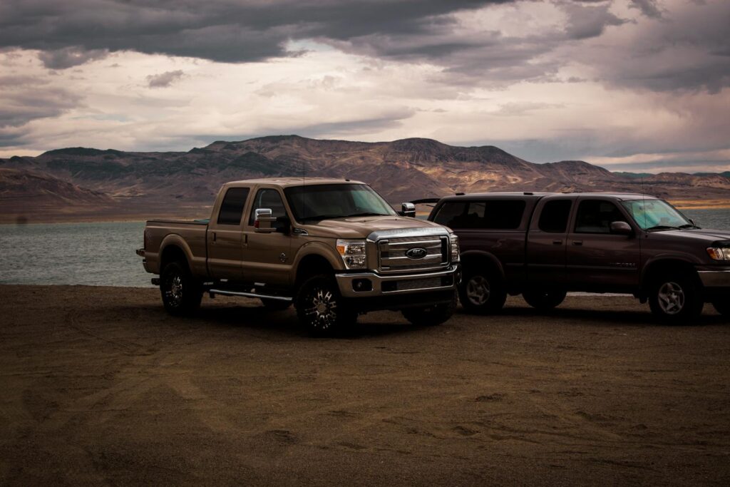 Photography of Vehicles Near Lake