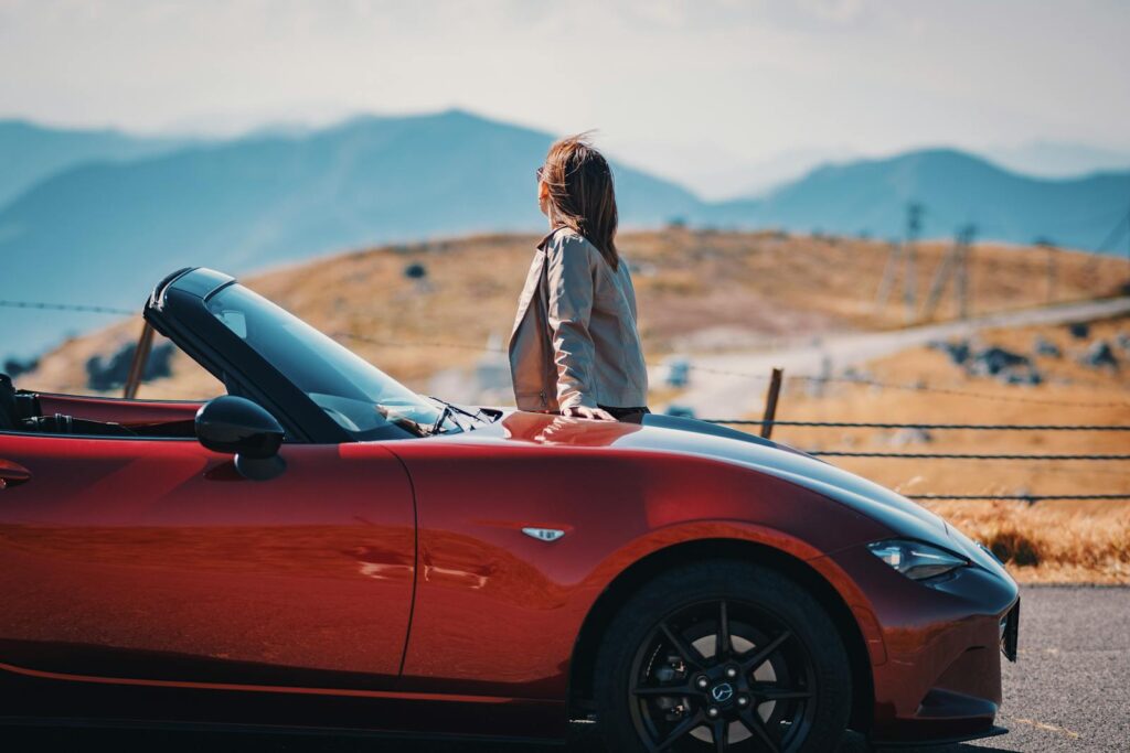 Woman in Jacket Standing by Mazda MX-5