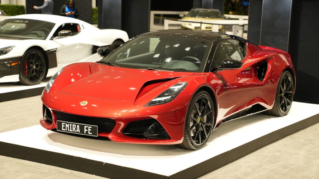 a red sports car on display at a car show