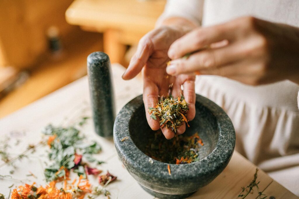 Close-up of Woman Preparing Herbs in Pounder