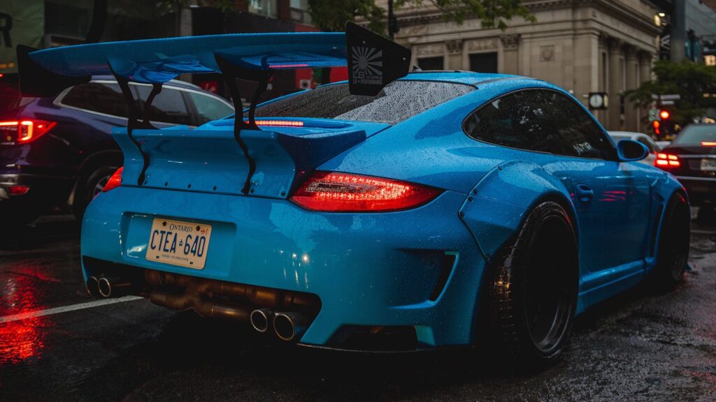 A blue porsche car parked on the street